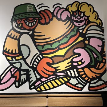 Shake Shack Studio City - a mural of a burger being carried by a man - Burgers Near Me - Studio City, California Shake Shack Studio City - a mural of a burger being carried by a man - Burgers Near Me - Studio City, California