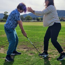 Murrieta Valley Golf Range - Coach Jenn positioning her student for a successful swing!