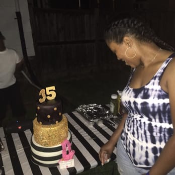Little CupCakery - a woman cutting a cake - Cupcakes Near Me