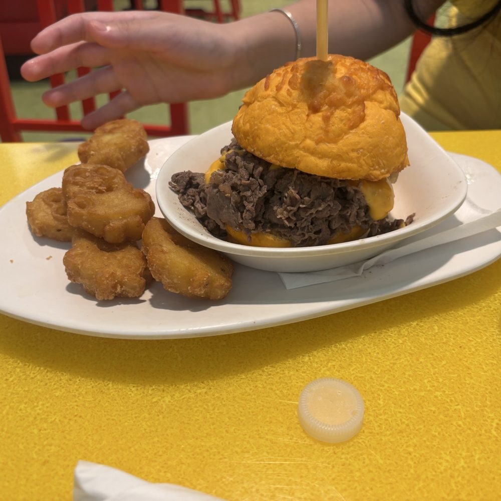 Illumination’s Minion Cafe - Steak and Cheese Ray Sandwich with Minion tots!! - New American Near Me - Orlando, Florida Illumination’s Minion Cafe - Steak and Cheese Ray Sandwich with Minion tots!! - New American Near Me - Orlando, Florida