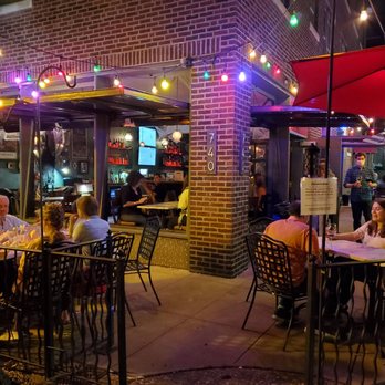 Barrio - a group of people sitting at tables outside of a restaurant - Beer Bar Near Me - Clayton, Missouri