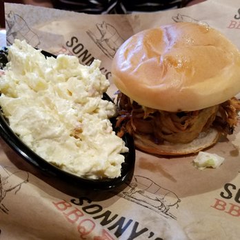 Sonny's BBQ - Sweet Carolina: Pulled Pork topped with homemade coleslaw and Sonny's Signature Carolina Sauce on a fresh toasted bun. - Barbeque Near Me - Spring Hill, Florida
