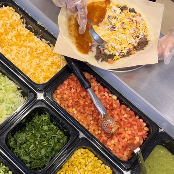 Quesada Burritos & Tacos - a person preparing a quesadilla - Mexican Near Me - North Vancouver, British Columbia Quesada Burritos & Tacos - a person preparing a quesadilla - Mexican Near Me - North Vancouver, British Columbia