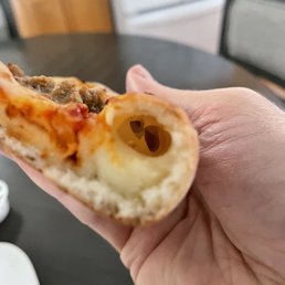 Less than 1/2 of "cheese stuffed" crust is filled with cheese. Less than 1/2 of "cheese stuffed" crust is filled with cheese.