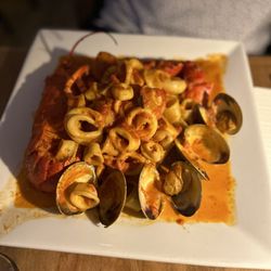 Barka - Seafood Pappardelle Saffron, scallops, calamari, clams, shrimp, lobster in a light tomato cream