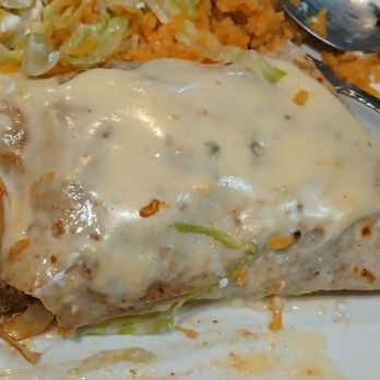 El Rodeo Mexican Restaurant - Cheesesteak burrito with onions and mushrooms inside,  rice and salad on the side. - Mexican Near Me - Columbus, Ohio