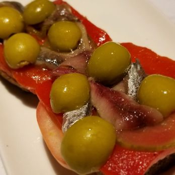 Ciutat Comtal - anchovies on a bread with. tomato, red pepper, and olivess - Tapas Bars Near Me - Barcelona, B Ciutat Comtal - anchovies on a bread with. tomato, red pepper, and olivess - Tapas Bars Near Me - Barcelona, B