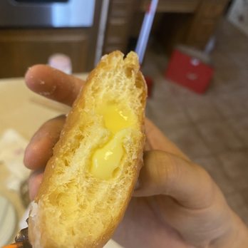 Best Donuts - a hand holding a half eaten donut - Donuts Near Me - Sugar Land, Texas