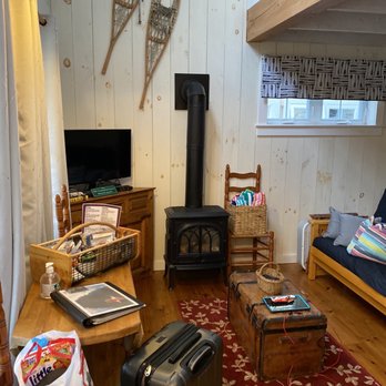 Sunapee Harbor Cottages - Living room with futon and heater - Resorts Near Me - Sunapee, New Hampshire Sunapee Harbor Cottages - Living room with futon and heater - Resorts Near Me - Sunapee, New Hampshire