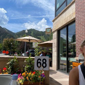 Spring Cafe - a woman sitting at a table outside - Juice Bars & Smoothies Near Me - Aspen, Colorado Spring Cafe - a woman sitting at a table outside - Juice Bars & Smoothies Near Me - Aspen, Colorado