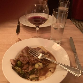 Abigail's Kitchen - Pork tenderloin with polenta and brussel sprouts. Thats Malbec wine in the background. - Cooking Classes Near Me - New York, New York