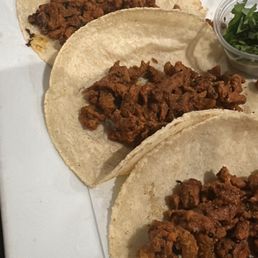 three tacos on a table three tacos on a table