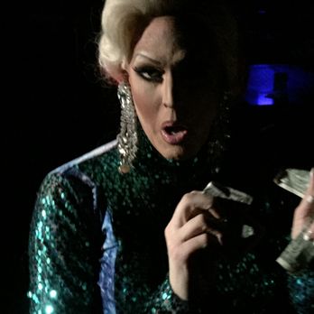 Station 4 - a woman in a green sequinned dress - Gay Bars Near Me - Dallas, Texas