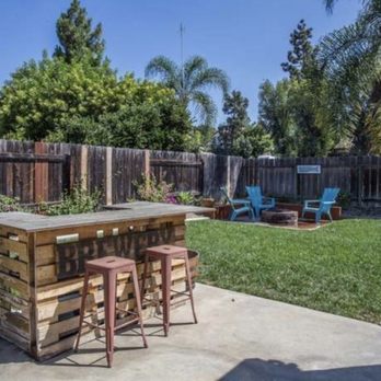 JH Landscaping & Construction - Our old back yard- palms, plants, and grass by H&J! - Landscaping Near Me