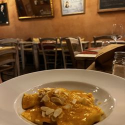 Osteria Tosca - Pasta filled with cheese and mint with yellow tomato sauce and almonds.