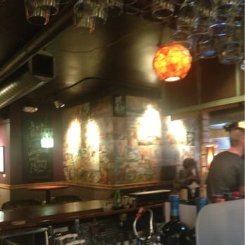 Art Bar - The glass rack above is a repurposed door. - Bars Near Me - Milwaukee, Wisconsin