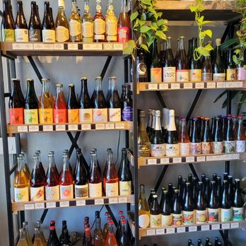 Flora & Ferment - a shelf full of bottles of wine - Cideries Near Me - Albany, California Flora & Ferment - a shelf full of bottles of wine - Cideries Near Me - Albany, California