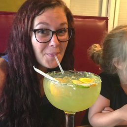 a woman drinking a margarita