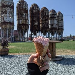 The Selkie Scoop - Strawberry scoop a few bites in. Great crunchy cone!