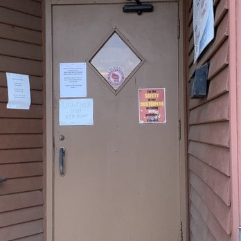 Dino's Bar & Grill - Dino's front door, with a note warning that they accept only cash or checks. - Pizza Near Me - Dodgeville, Wisconsin