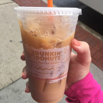 Dunkin' -  a hand holding a cup of iced coffee - Coffee & Tea Near Me - Woburn, Massachusetts