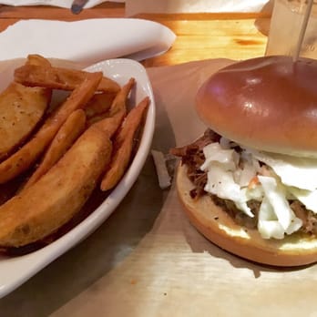 The Station - BBQ beef sandwich with a side of wedges. - Salad Near Me - Raleigh, North Carolina The Station - BBQ beef sandwich with a side of wedges. - Salad Near Me - Raleigh, North Carolina