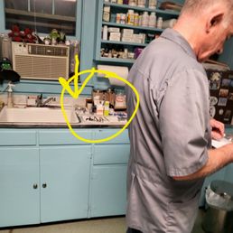 The counter is full of used needles piled on paper towels next to the sink. The counter is full of used needles piled on paper towels next to the sink.