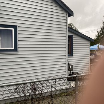 P&E Surfaces - a view of a house through a chain link fence - Pressure Washers Near Me - Everett, Washington P&E Surfaces - a view of a house through a chain link fence - Pressure Washers Near Me - Everett, Washington