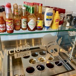Vicious Biscuit - Condiment bar with different butters, jams, & hot sauces