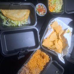 Two tacos, beans, rice, and chips and salsa