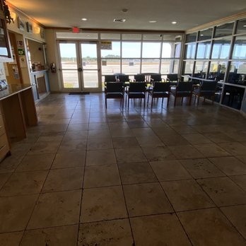 The Landing Strip Café - overflow waiting area with TV and a clear view to the runway - New American Near Me - Okeechobee, Florida The Landing Strip Café - overflow waiting area with TV and a clear view to the runway - New American Near Me - Okeechobee, Florida