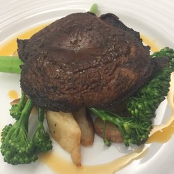 The Dinner Detective - 3" mushroom that was sadly overcooked, there's a singe layer of potato pieces and 2 sprigs of broccoli under it.