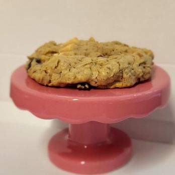 Better Batter Bakery - a cookie on a pink cake stand - Desserts Near Me