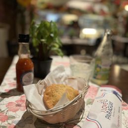 a basket of bread and a bottle of sauce a basket of bread and a bottle of sauce