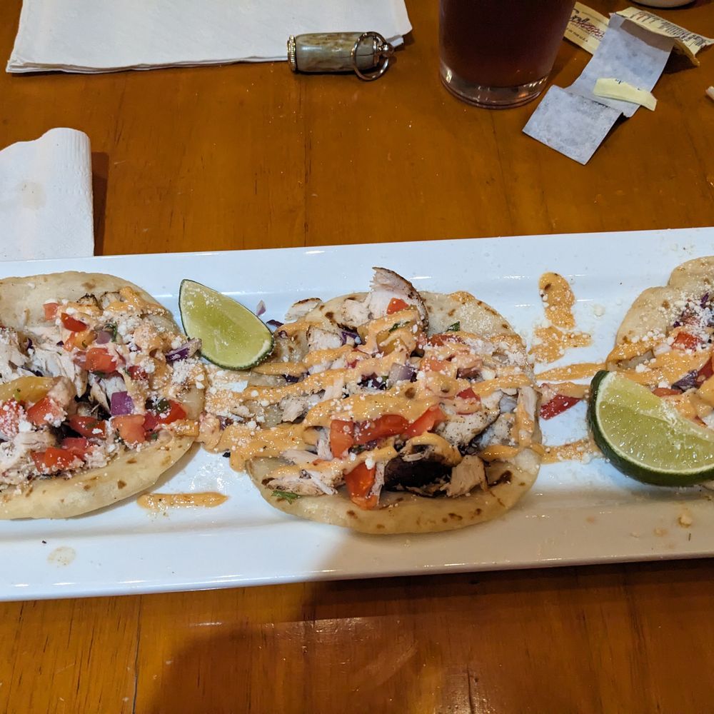 three tacos on a white plate three tacos on a white plate