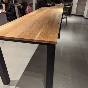 Quantum Coffee - a wooden table with metal legs - Cafes Near Me - Toronto, Ontario