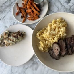 Steak entree with side of Mac, sweet potato fries, and chicken Steak entree with side of Mac, sweet potato fries, and chicken