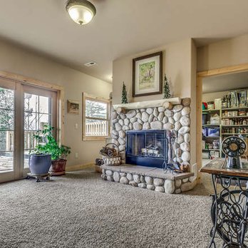 Above Treeline Construction - a living room with a stone fireplace - General Contractors Near Me - Woodland Park, Colorado Above Treeline Construction - a living room with a stone fireplace - General Contractors Near Me - Woodland Park, Colorado