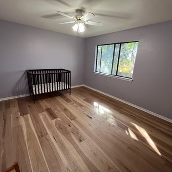 Landers Premier Flooring - a baby crib in a room - Flooring Near Me - Austin, Texas