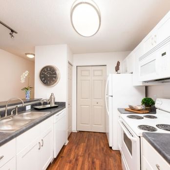 Butternut Ridge - Kitchen with white cabinets and a white stove and a sink - Apartments Near Me - North Olmsted, Ohio Butternut Ridge - Kitchen with white cabinets and a white stove and a sink - Apartments Near Me - North Olmsted, Ohio