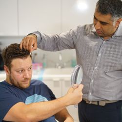 Northwestern Hair Restoration - Dr. Vinay making finishing touches during a hair restoration procedure.