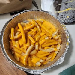 Mario's Pizza - Cheese fries. Lot of extra space in that container. Fries undercooked. No crunch.
