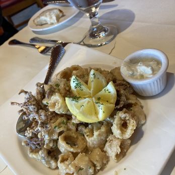 Scott's Seafood - Fried calamari with a drizzle of garlic butter and tartar sauce for dipping. - Seafood Near Me - Oakland, California Scott's Seafood - Fried calamari with a drizzle of garlic butter and tartar sauce for dipping. - Seafood Near Me - Oakland, California