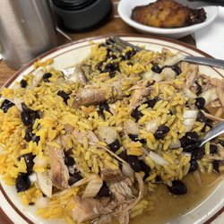 Pipo's Restaurant - Yellow rice, black beans, and roasted pork with onion and Crystal hot sauce.  Mmmmmmm good.