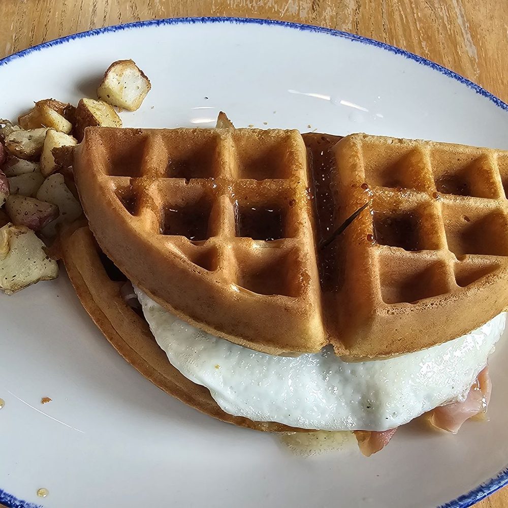 22 Square Restaurant - "The Gourmand" (shaved GA Smoked Ham, Gruyere Cheese, Fried Egg over easy, inside a Belgian Waffle w/Breakfast Potatoes on the side. - American Near Me - Savannah, Georgia