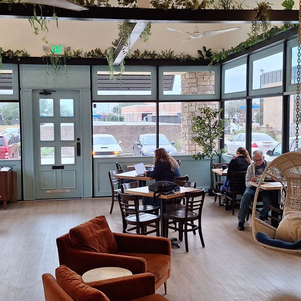Java Owl Coffee House - I chose one of the tables but tried those hanging chairs for a minute.  The big windows toward the front bring in a lot of light. - Coffee & Tea Near Me - Nassau Bay, Texas