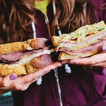 Jimmy John's - a woman holding a sandwich - Fast Food Near Me - Draper, Utah Jimmy John's - a woman holding a sandwich - Fast Food Near Me - Draper, Utah