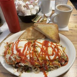 Loaded shreds! Hashbrowns loaded with onions, green peppers, bacon, sausage and ham covered in melted cheese and 2 eggs.