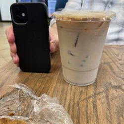 Turbo Grill - A 20oz iced latte next to an iPhone 12 mini.