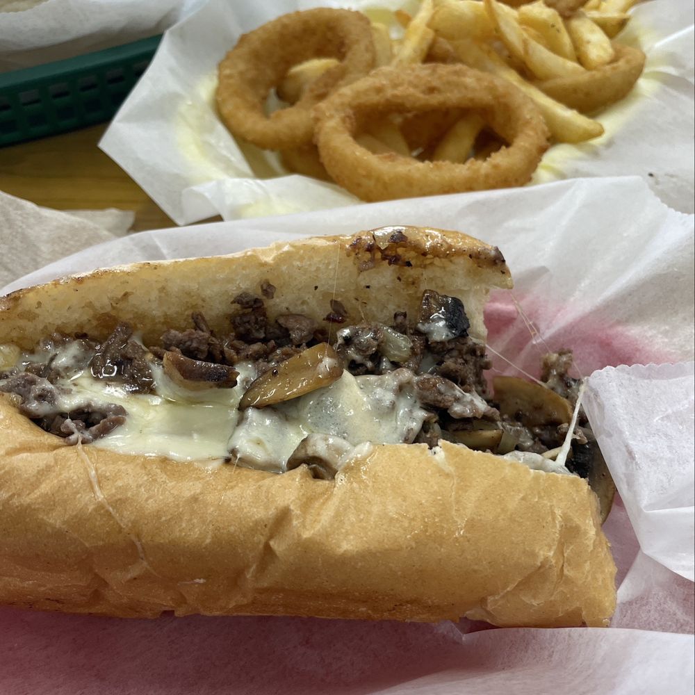 Mushroom Philly Sandwich; greens fours and basket of fries/onion rings